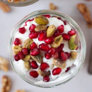 An easy, 5 minute holiday parfait recipe, featuring pistachio, pomegranate and nutty granola that is sure to brighten your day. #GlutenFree and #Vegan options!